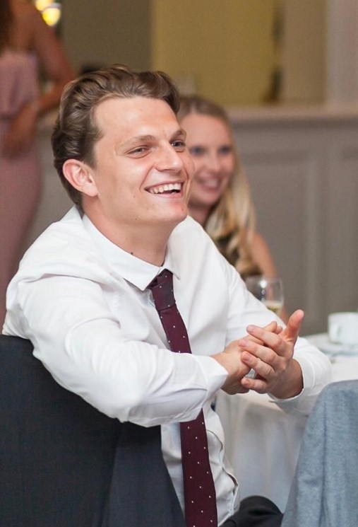 worker crushed lifting operation - A photo of Jack Phillips wearing a tie and smiling. He's seated a table - a company was fined £1.6m after he was crushed to death.