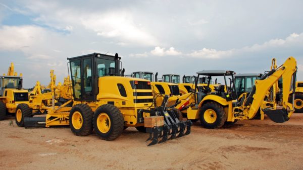 Image of grader and excavator construction machinery in a yard - The Trade Remedies Authority has proposed that a new anti-dumping measure of up to 83.5% be applied to imports of excavators from China to the UK.