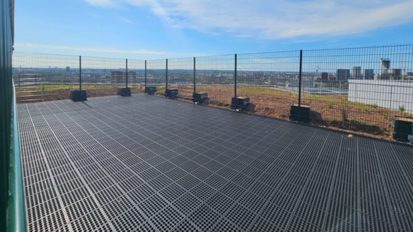 The drone landing area made of rubber. There's a fence surrounding it - a contractor has installed a drone landing area at a major NHS hospital.