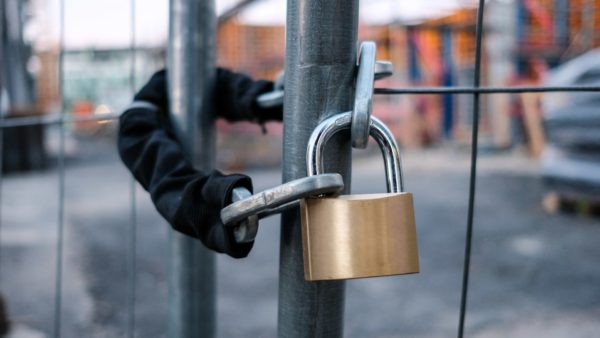 Chain and padlock on gate at construction site - a legal expert from Womble Bond Dickinson explains in this article what happens to employees when a contractor collapses.