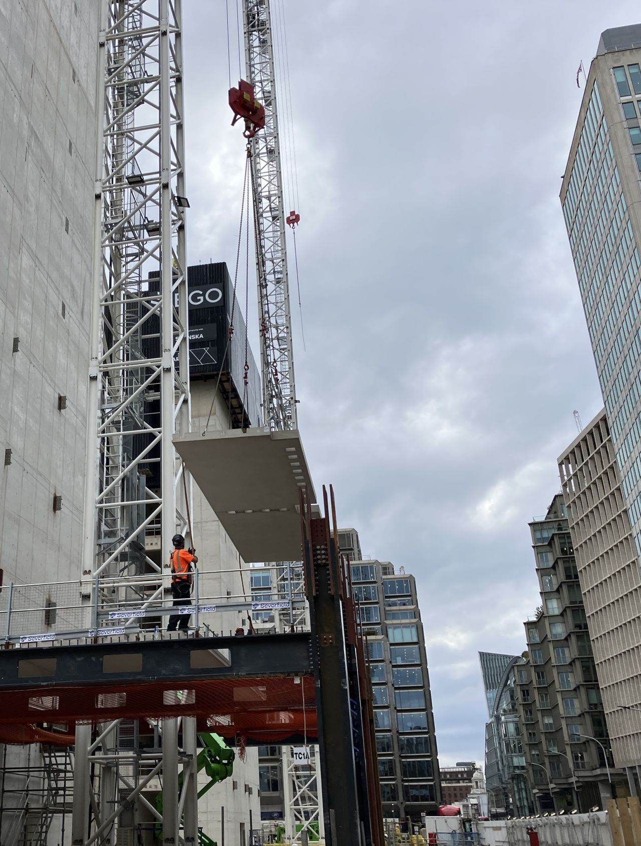 GGBS Skanska - A precast plank being moved in place at a construction site - Skanska is using precast planks made of 50% slag cement at its 105 Victoria Street project