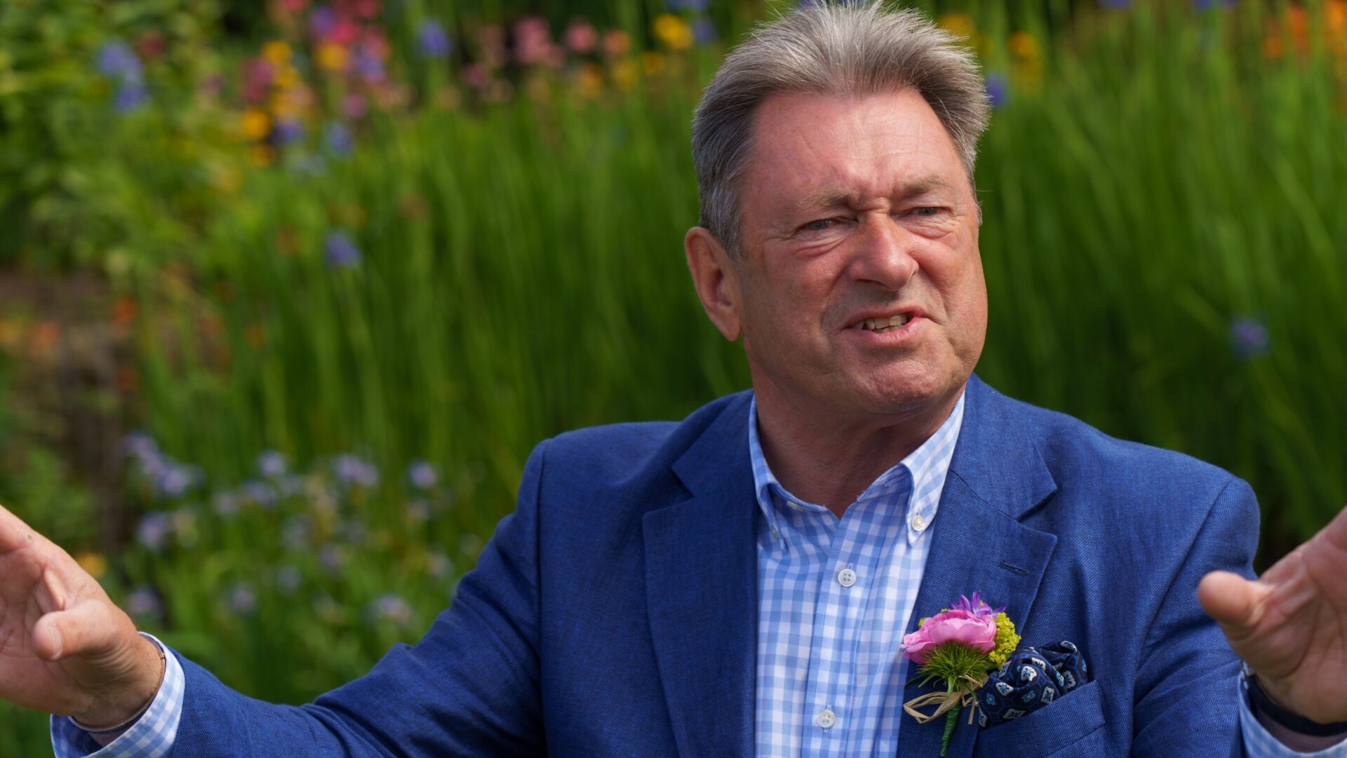 Alan Titchmarsh with a blue jacket in a garden - he is calling for compensation to the Royal Horticultural Society after it suffered multi-million losses as a result of the ongoing roadworks at the M25/A3