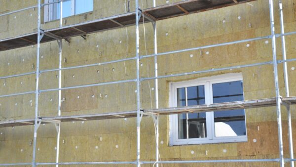 House facade renovation with mineral wool insulation boards outdoors - the government has suspended 39 businesses who installed poor-quality insulation.