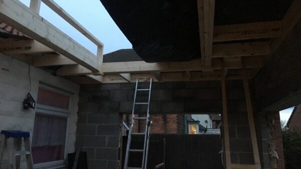 A construction site with a ladder and some wooden beams on the roof area - a construction director was handed a suspended prison sentence after a roofer fell from height and died from his injuries.