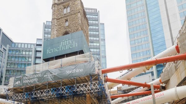 A construction site with a medieval tower suspended on stilts