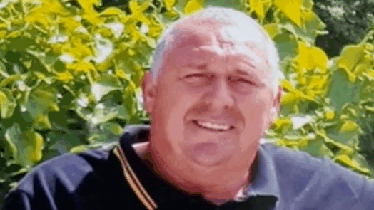 A mugshot of a man smiling at the camera - Gary Anstey was killed when a collapsing wall fell onto him