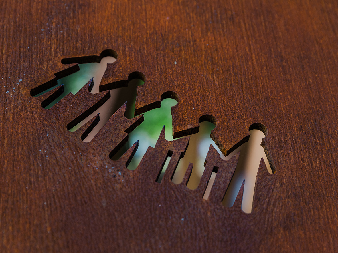 Local students designed a perforation for the canopy backdrop, featuring five children holding hands. Image: Studio Idir