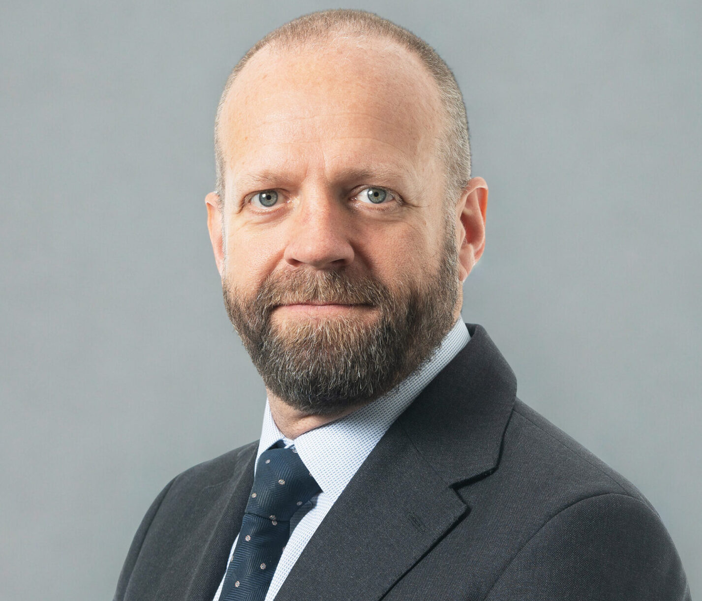 Mugshot of a man smiling at the camera