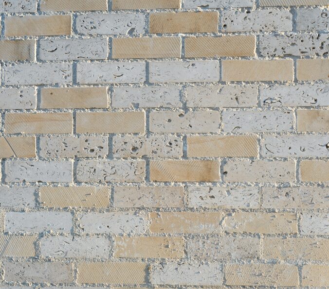 Close up of a wall made of light-coloured bricks