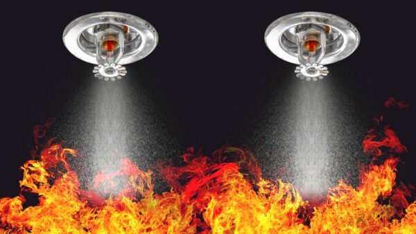 Image of sprinklers working over fire for fire safety design story