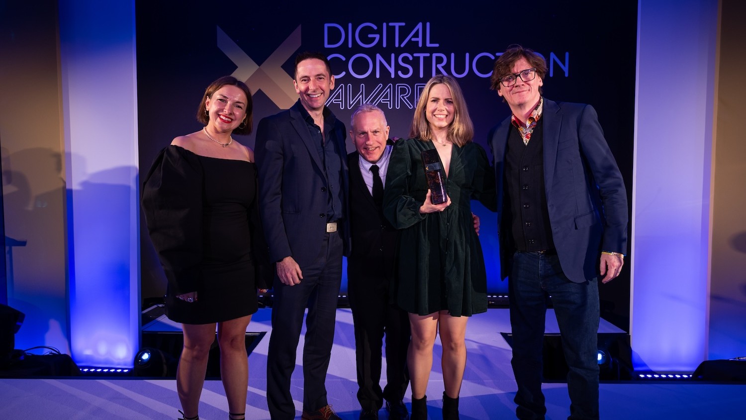 Jason Whittall (second left) and Vicki Reynolds (second right) of ONE Creative Environments collect their trophy from Ed Byrne (far right), Justin Kirby of Start with Smart (centre) and Karolina Orecchini from Digital Construction Week. Image: © 2026 – ASV Photography Ltd. www.ASVphotos.com
