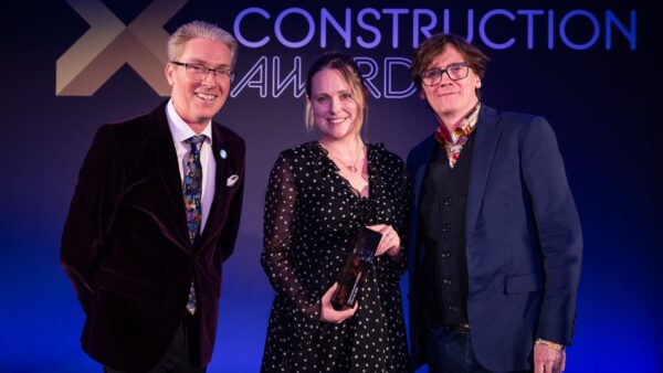 Dr Melanie Robinson received the trophy on behalf of Dr Anne Kemp OBE from Ed Byrne (right) and Justin Stanton of DC+ (left). Image: © 2026 – ASV Photography Ltd. www.ASVphotos.com