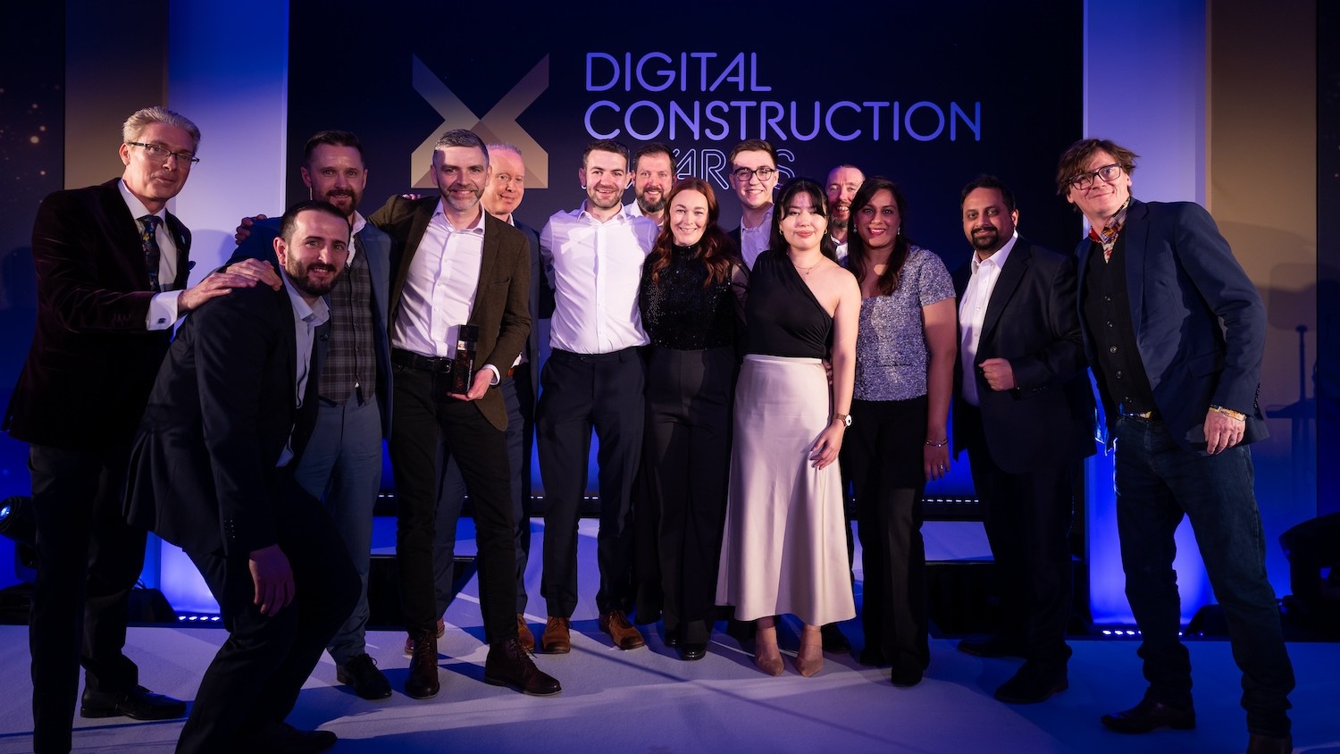 McLaren Construction receive the trophy from Ed Byrne (far right), Will Mann of CM (fifth left) and Justin Stanton of DC+ (far left). Image: © 2026 – ASV Photography Ltd. www.ASVphotos.com
