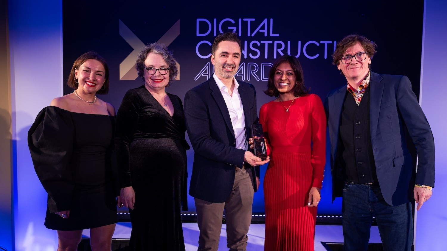 Quintessential Design collect the trophy from Ed Byrne (far right), awards judge Su Butcher (second left) and Karolina Orecchini from Digital Construction Week (far left). Image: © 2026 – ASV Photography Ltd. www.ASVphotos.com