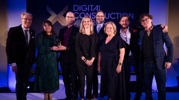 Dr Melanie Robinson received the trophy on behalf of Dr Anne Kemp OBE from Ed Byrne (right) and Justin Stanton of DC+ (left). Image: © 2026 – ASV Photography Ltd. www.ASVphotos.com