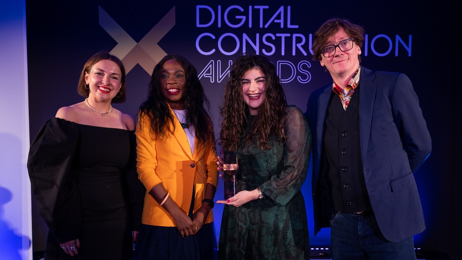 Emine Rachel Taylor-Unlu collects her trophy from Ed Byrne (far right), Ola Obadara from the CIOB (second left) and Karolina Orecchini of Digital Construction Week (far left). Image: © 2026 – ASV Photography Ltd. www.ASVphotos.com
