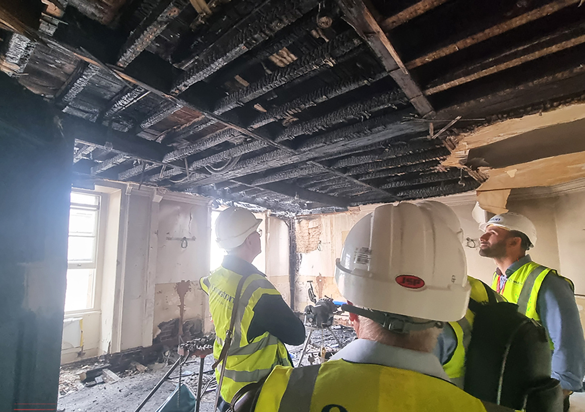 Inspecting the aftermath of the fire. Image: MSMR Architects