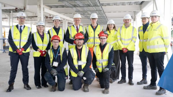 Some of Balfour Beatty’s early-career staff helping deliver Edinburgh Airport’s expansion programme pose with Scotland’s first minister John Swinney, standing fourth from left, and Nick Rowan, managing director of Balfour Beatty Scotland, standing third from left. Image: Balfour Beatty